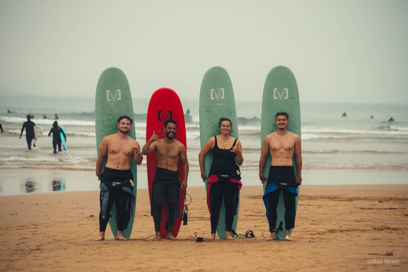 Group of surfers with boards on the beach, Taghazout
